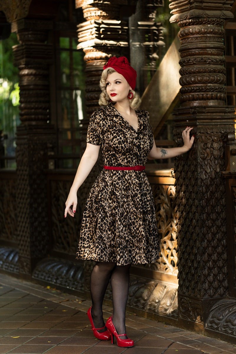 Model wears our short sleeve Penelope dress, in brown leopard print, in a street