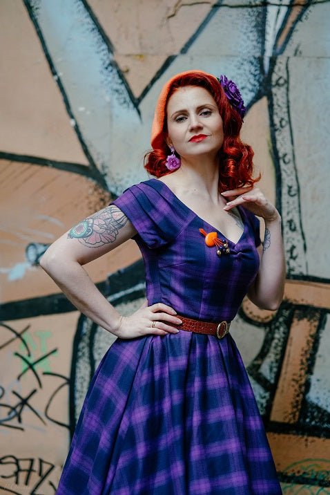Influencer wearing purple tartan check swing dress with petticoat close up