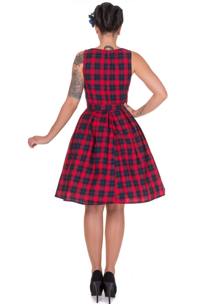 Model wears our sleeveless Annie dress in red, with blue checks, back view