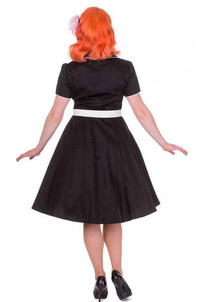Model wears our Penelope diner button top dress, in black and white, back view