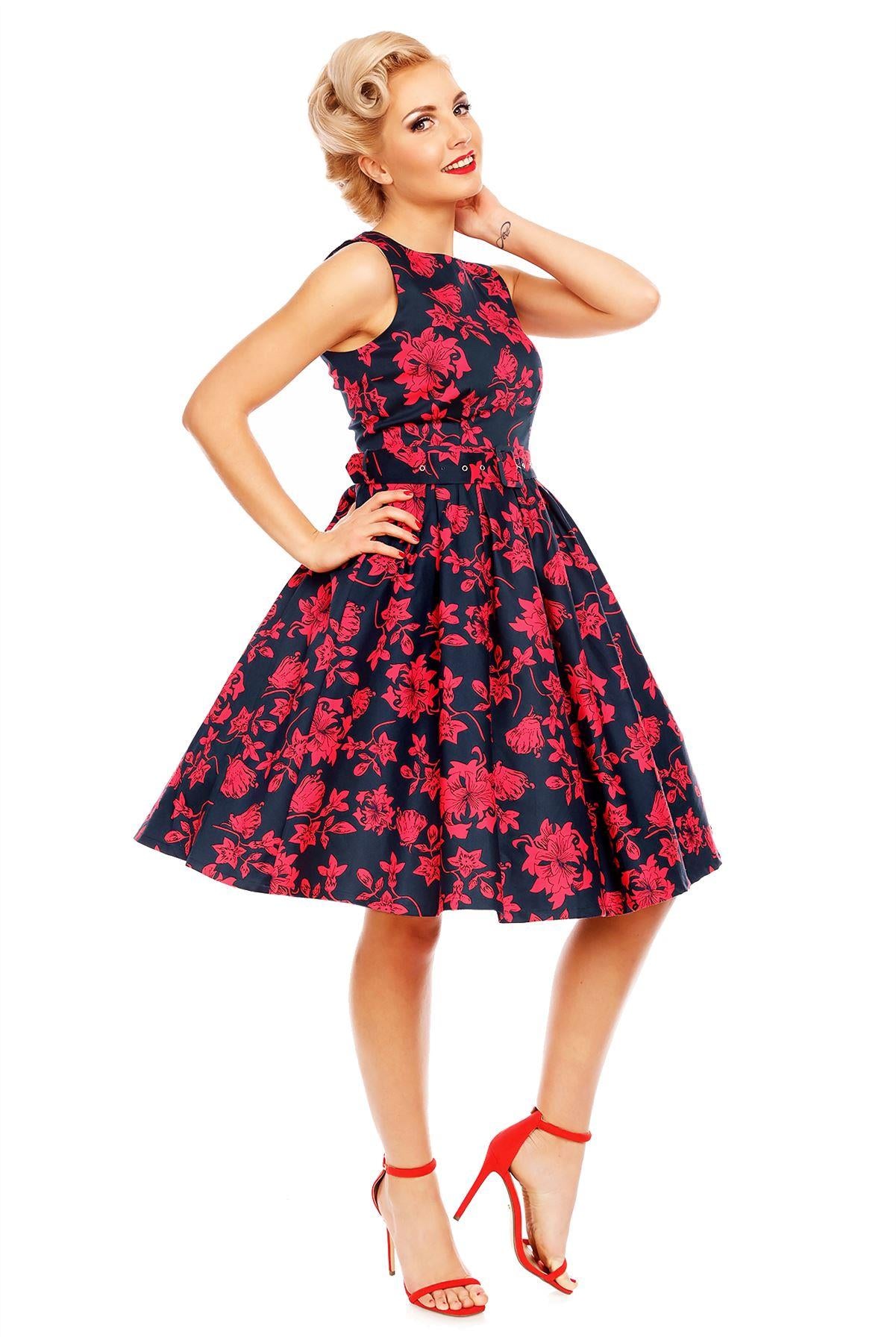 Model wearing Retro Swing Dress in Navy Blue/Red floral print, side view