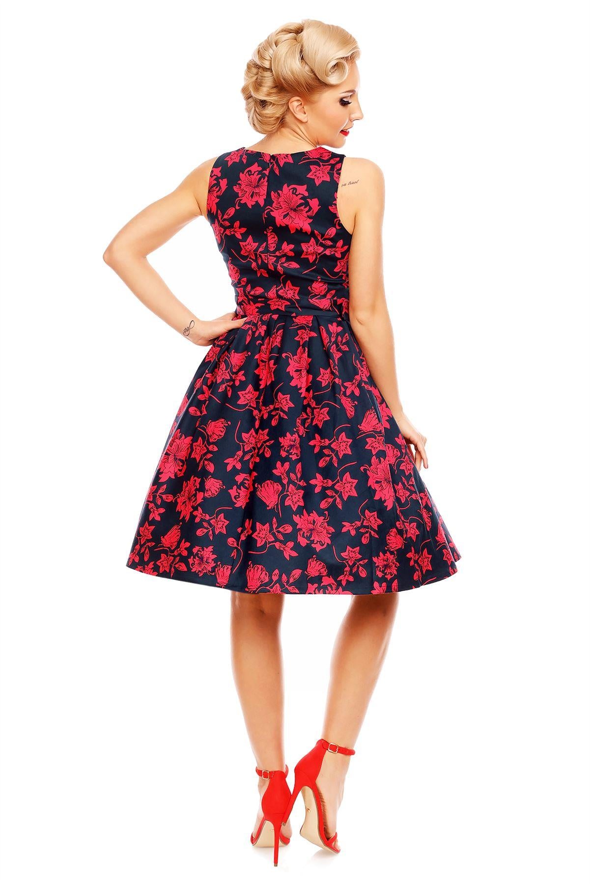Model wearing Retro Swing Dress in Navy Blue/Red floral print, back view