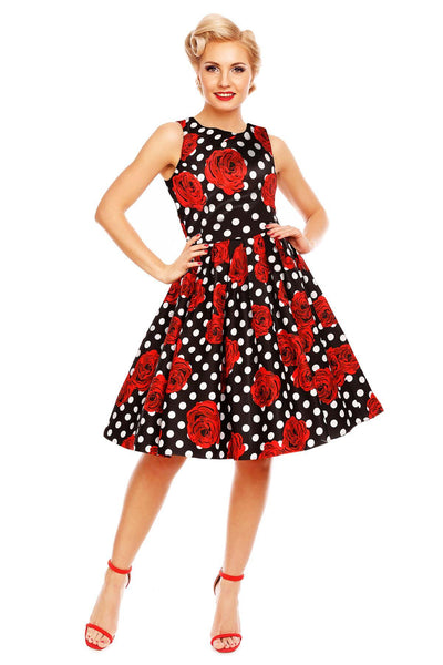 Model wears our Annie retro dress in black/red roses and white spot print, front view