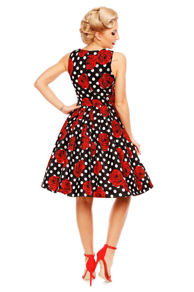 Model wears our Annie retro dress in black/red roses and white spot print, back view