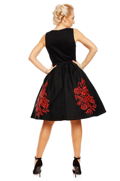 Model wearing Annie Embroidered Roses Swing Dress in Black/Red, back view