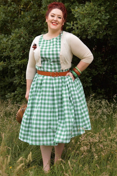Blogger wearing green white gingham check print dress with accessories