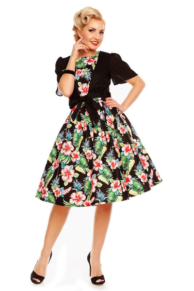 Model wearing our Annie dress, in black/pink orchid floral print, front view, with accessory