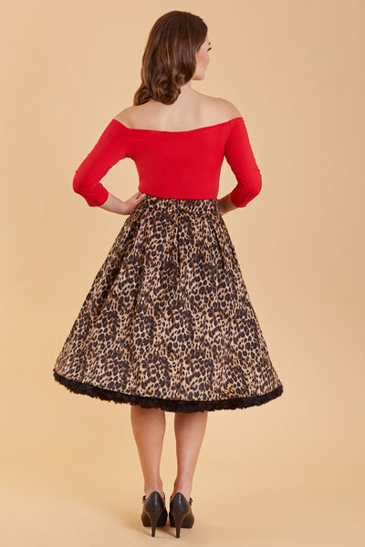 Model wearing leopard print skirt with black petticoat and red top