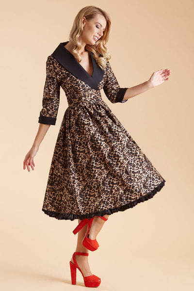 Model wearing our tiffany lapel coat dress, in brown leopard print, with black petticoat, side view