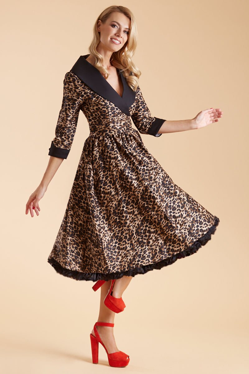 Model wearing our tiffany lapel coat dress, in brown leopard print, with black petticoat, side view