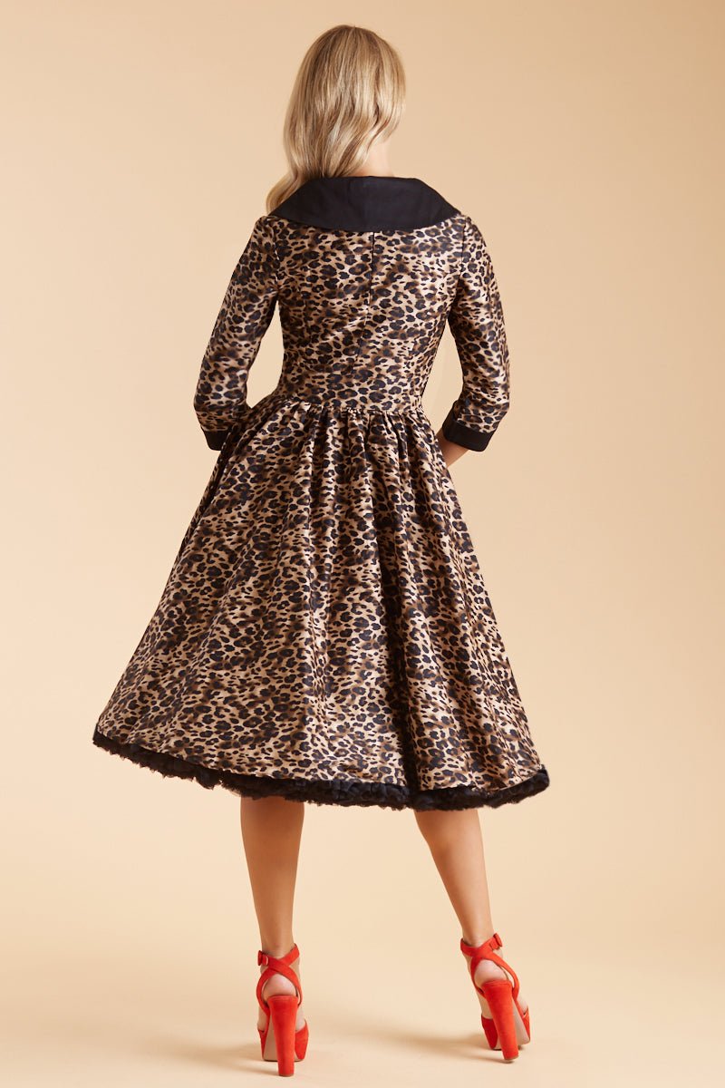 Model wearing our tiffany lapel coat dress, in brown leopard print, with black petticoat, back view