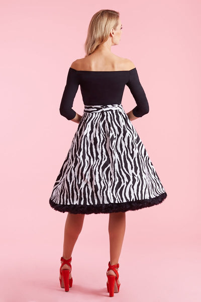 Model wearing zebra print flared skirt back view
