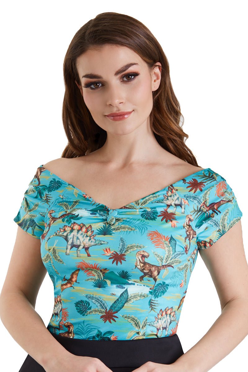 Model wearing blue dinosaur/pterosaur print top, close up