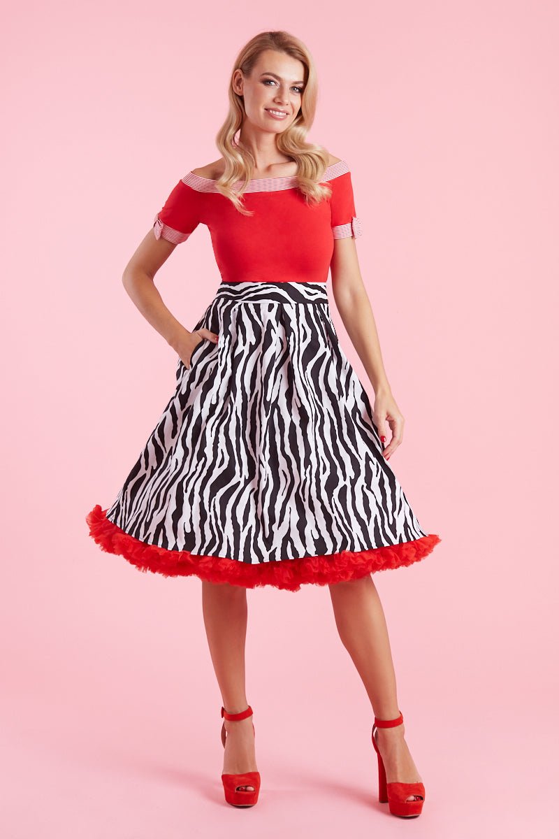 Model wearing zebra print flared skirt with red petticoat