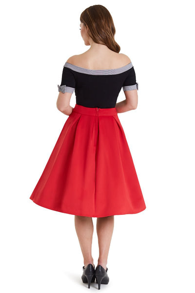 Model in off shoulder black top with striped trims back view
