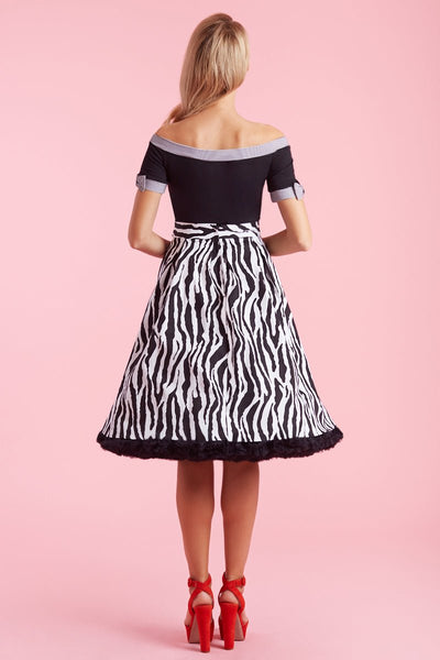 Model in off shoulder black top with striped trims back view