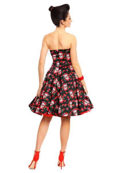 Model wearing the strapless Melissa dress, in black, with red roses and white sugar skulls, back view