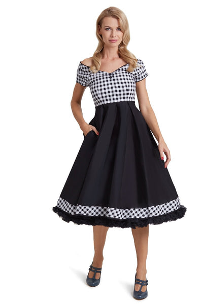 Model wears our short sleeved Lily dress, in black and white check gingham print on top, front view