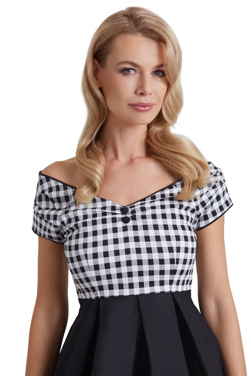 Model wears our short sleeved Lily dress, in black and white check gingham print on top, close up view