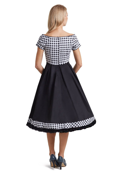 Model wears our short sleeved Lily dress, in black and white check gingham print on top, back view