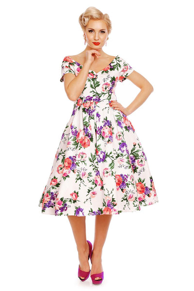Model wearing our Lily, off-shoulder 50's Evening Dress in White, with pink and purple flowers, front view