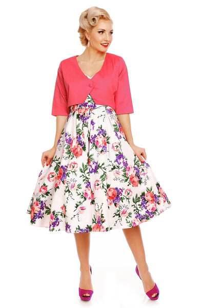 Model wearing our Lily, off-shoulder 50's Evening Dress in White, with pink and purple flowers, with a pink jacket