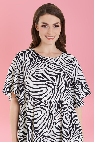 Model in sleeved floaty maxi dress in zebra print close up