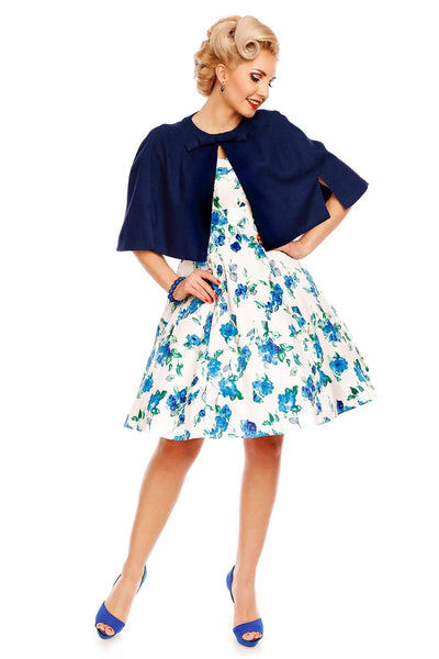 Model wearing white/blue floral dress with a bolero