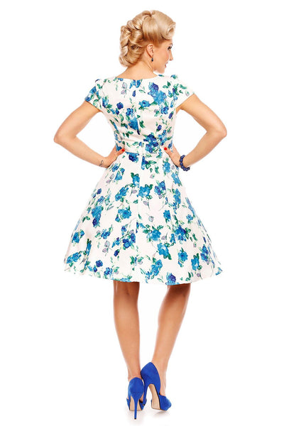 Model wearing white/blue floral dress back view