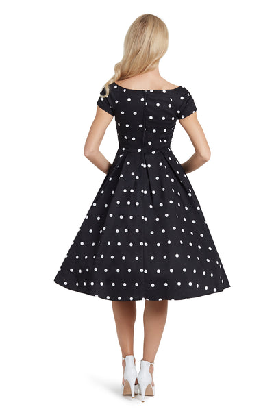 Model in Black Off Shoulder Dress with White Polka Dots Back View