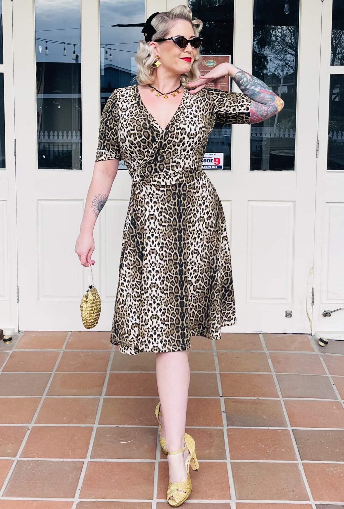 Model wearing brown leopard print wrap dress with short sleeves