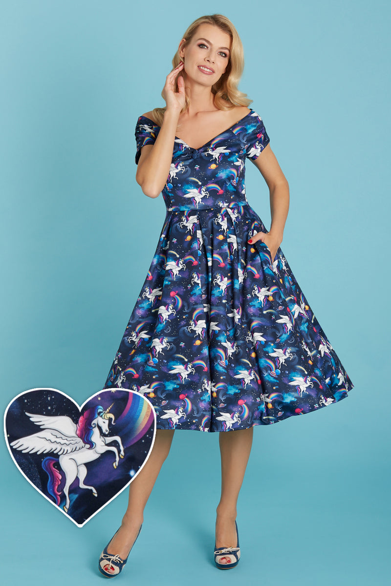 Model wears our V neck, short sleeved swing dress, in navy blue unicorn space rainbow print, front view