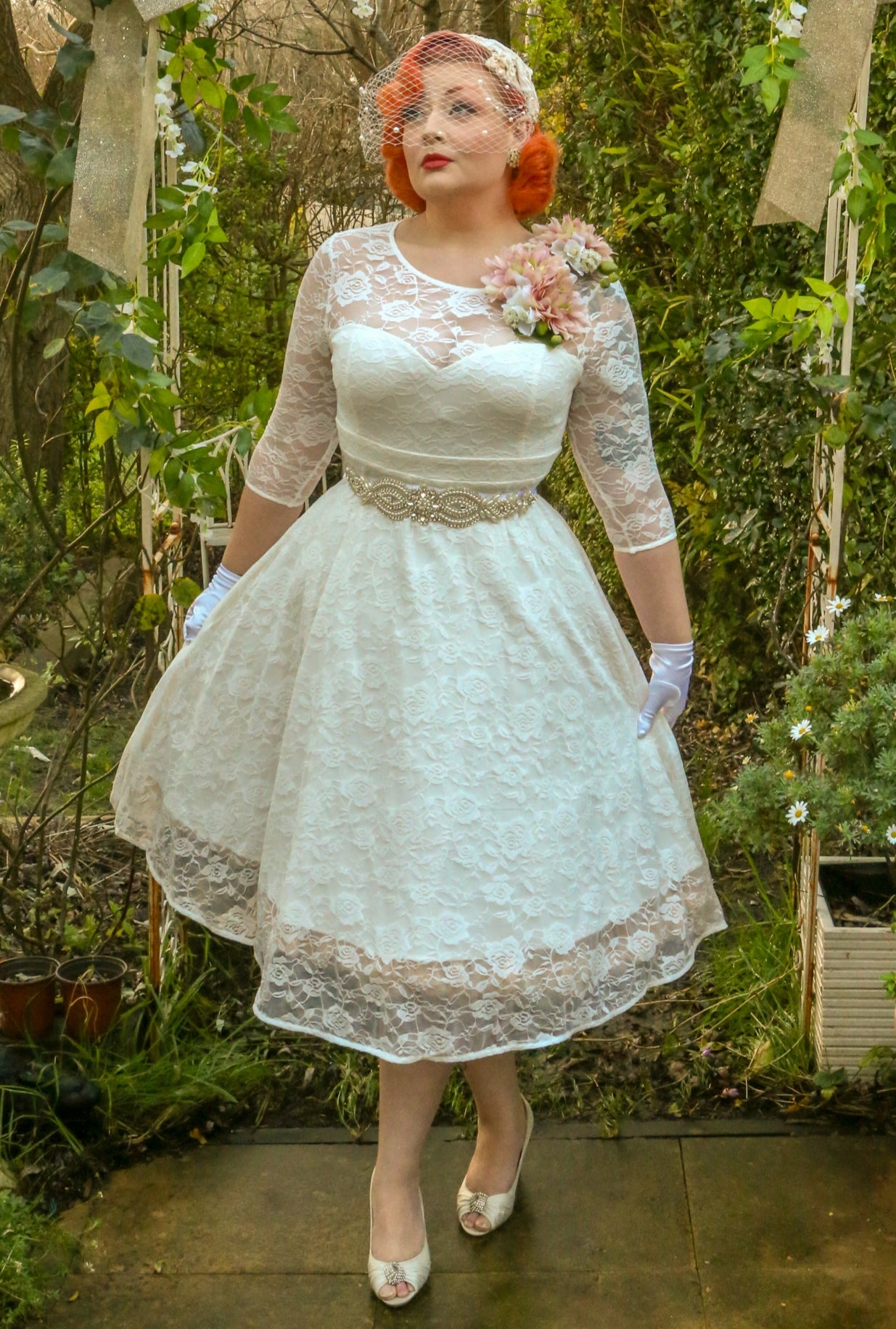 Customer wears our lace covered, sleeved vintage-style wedding dress