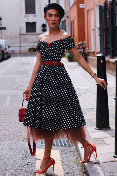 Customer wears our Lily short sleeved swing dress, in black, with white polka dots, with accessories