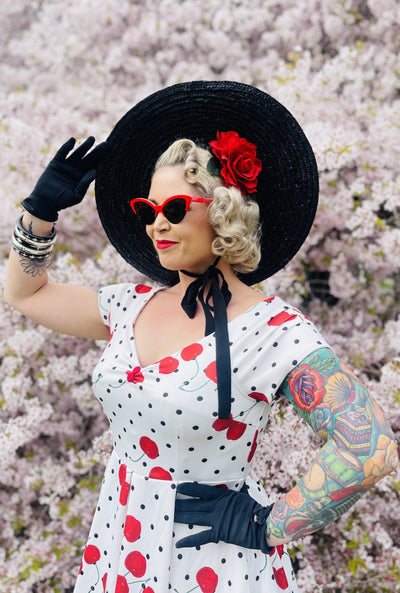 Influencer wearing Rockabilly Polka Dot & Cherry White Swing Dress close up