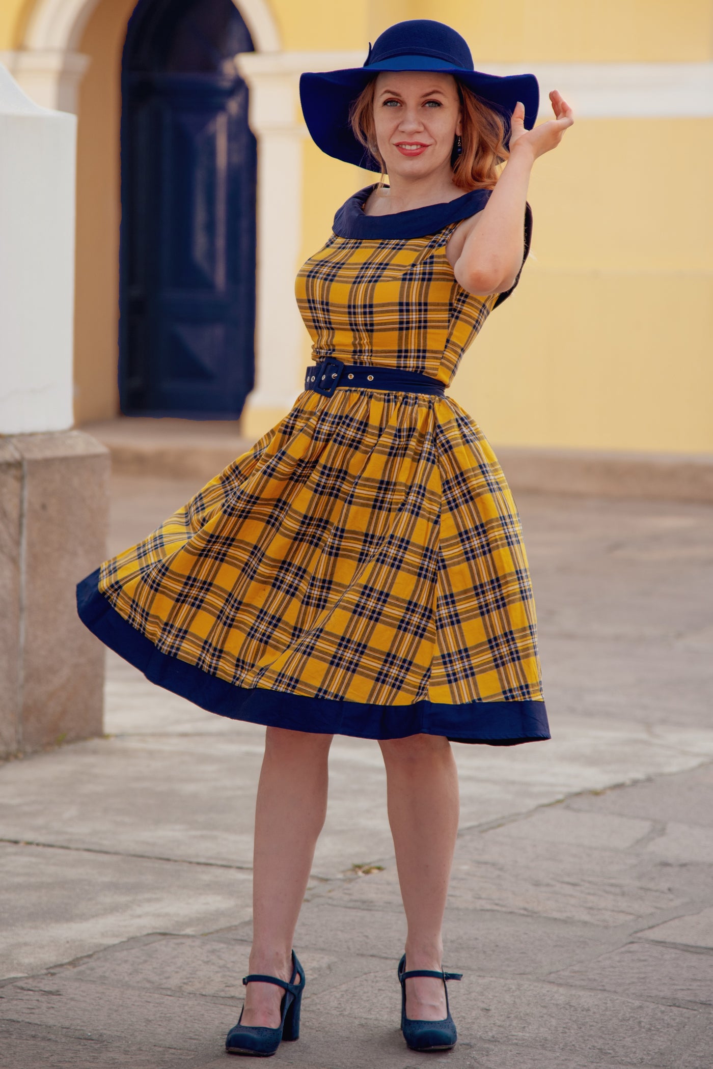 Blogger wears our sleeveless swing dress, in yellow navy blue tartan print