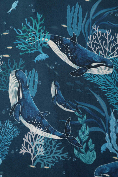 Close up fabric view of blue whale print sleeved swing dress in blue