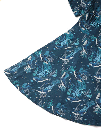 Close up view of blue whale print sleeved swing dress in blue
