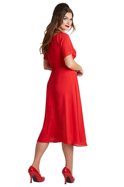 Model wearing our Meredith floaty casual dress, with short sleeves,  in red, side view
