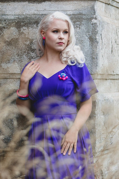woman wears our Meredith floaty casual dress, with short sleeves, in dark blue, with accessories