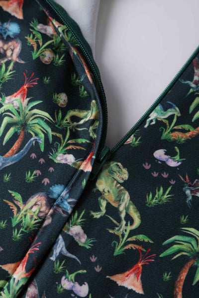 Close up View of Dinosaur and Forest Print Long Sleeved Dress in Green