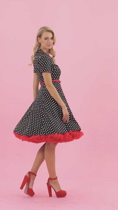 Video of a model wearing a Black Retro Diner with  White Polka Dots.