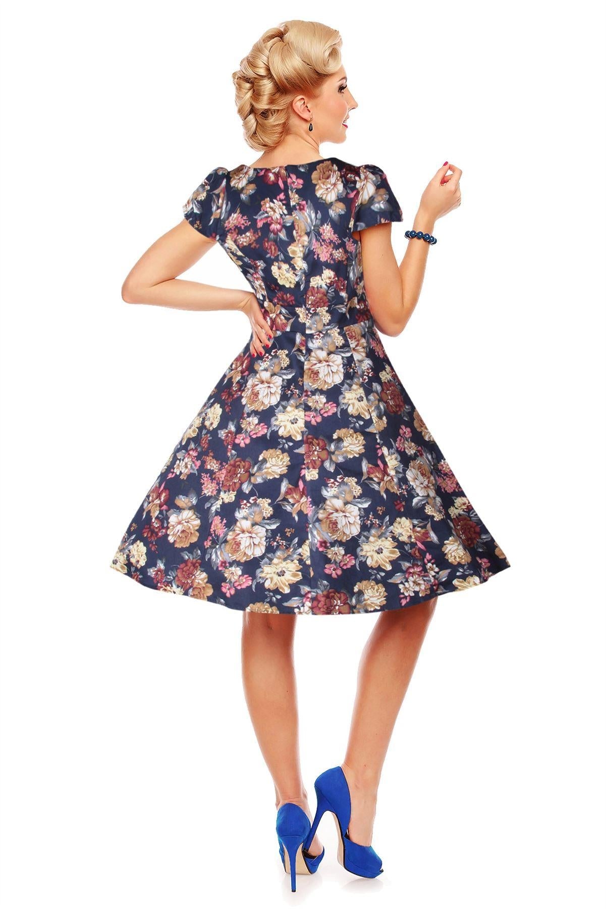 Model wearing our cap sleeve Claudia dress, in navy blue, with beige flowers, back view