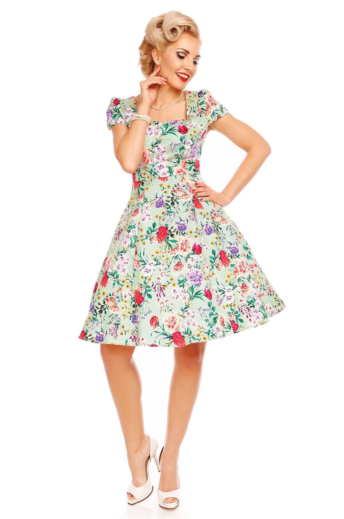 Model wearing Claudia, our short sleeve dress, in green, pink floral print, front view