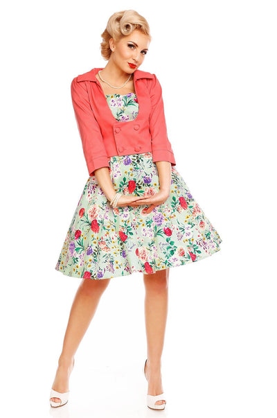 Model wearing Claudia, our short sleeve dress, in green, pink floral print, front view, with jacket