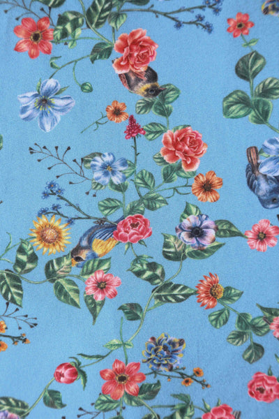 Close up view of Hummingbird Print Long Sleeved Dress in Blue