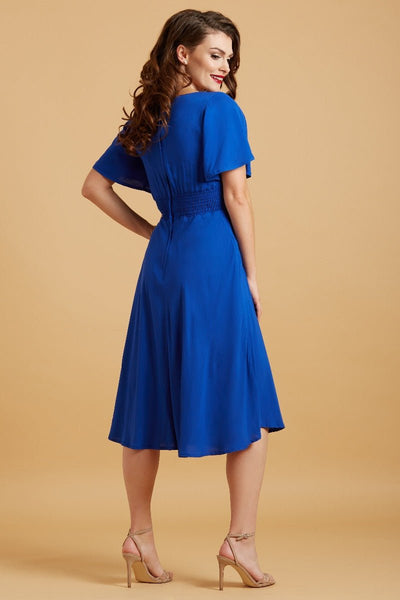 Model wears our Janice petal sleeve swing dress in dark blue, back view