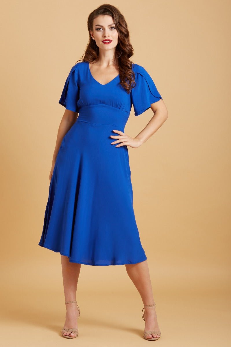 Model wears our Janice petal sleeve swing dress in dark blue, front view