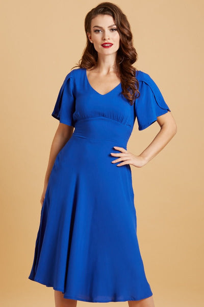 Model wears our Janice petal sleeve swing dress in dark blue, front view
