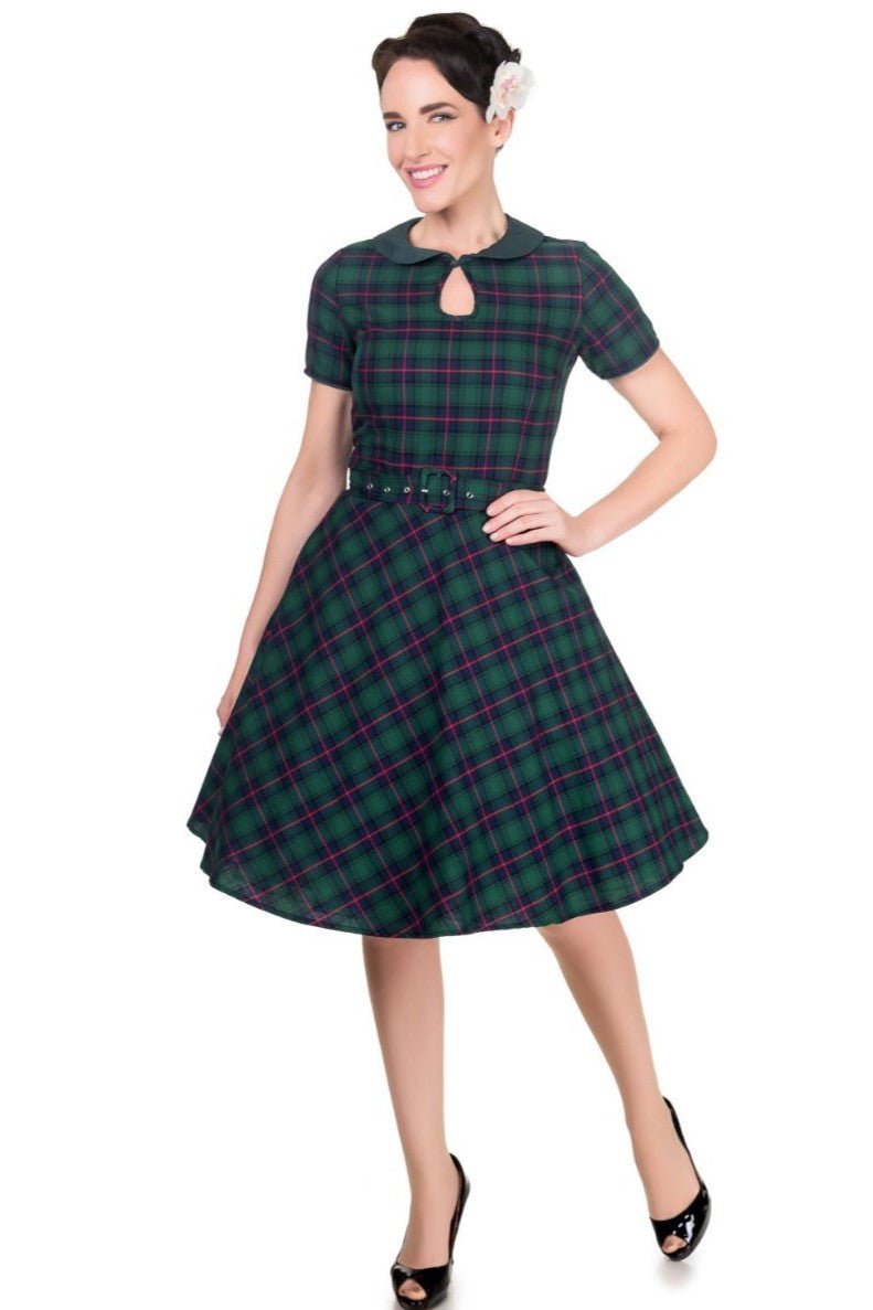 Model wearing Evelyn Retro Check Swing Dress in Green, with full skirt, front view